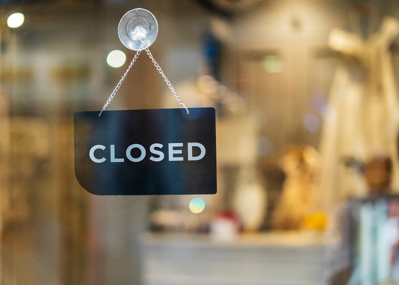 a sign on a window. Containing the words: closed