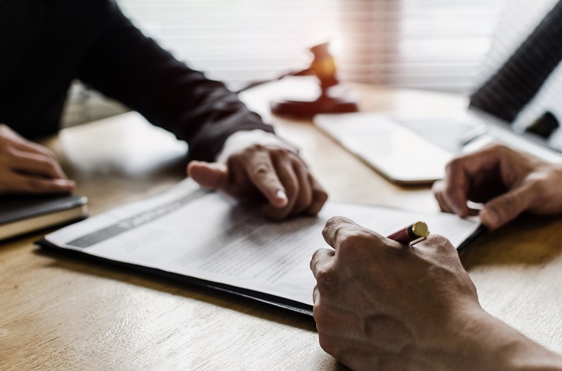 a person signing a document.