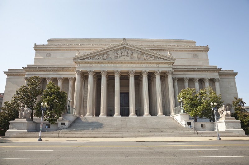 a large white building with columns. Containing the words: archives of the United States of America