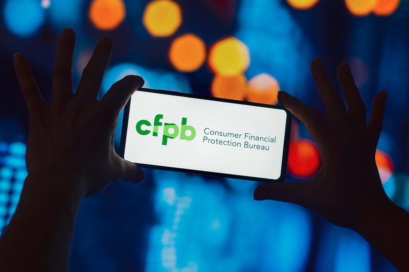 the Consumer Financial Protection Bureau (CFPB) logo is displayed on a smartphone