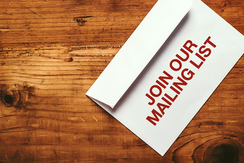 a white envelope with red text on it. Containing the words: join our mailing list