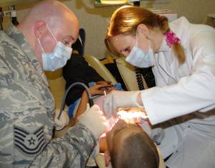 a military personnel performing a dental procedure.