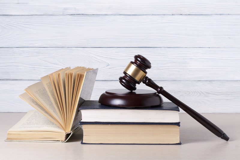 a gavel on top of a stack of books.