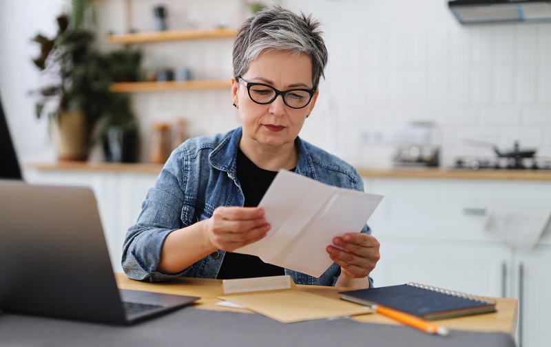 a person reading a piece of paper.