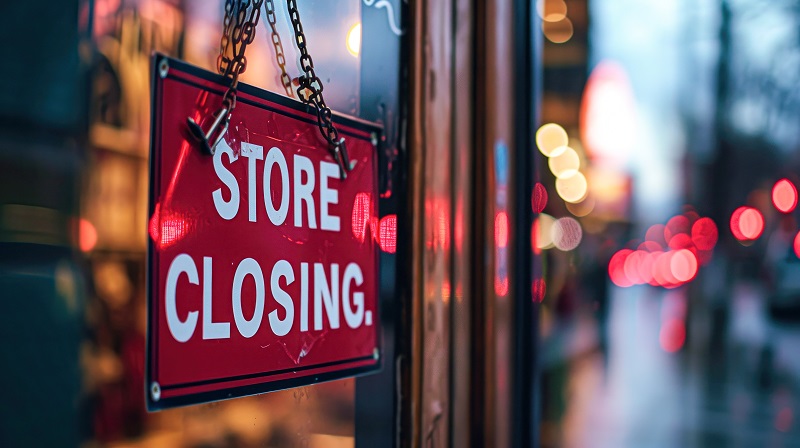 Horizontal Close Up Shot Of Store Closing Sign On Business