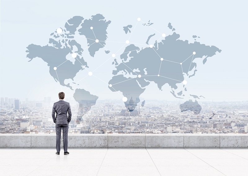 a person standing on a rooftop looking at a map.