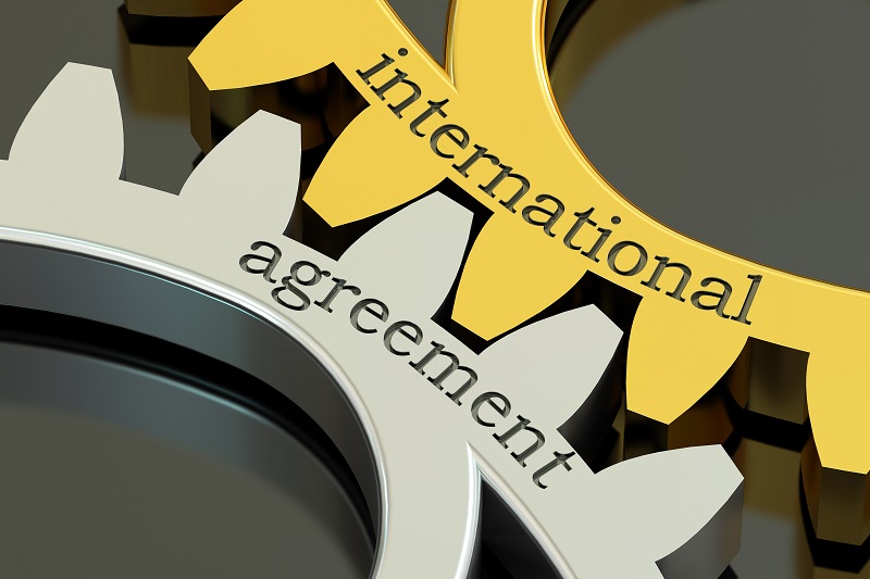 a close-up of a gear. Containing the words: international agreement