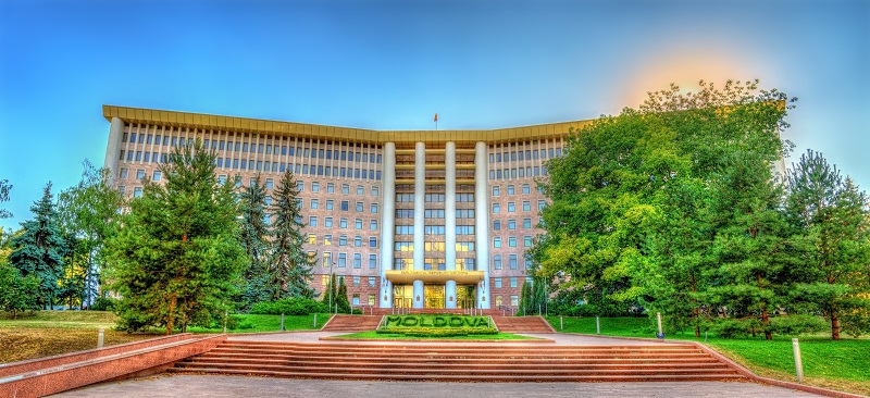 a building with stairs leading to the front. Containing the word: moldova