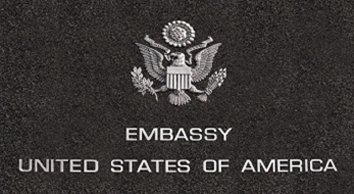 a close-up of a logo. Containing the words: embassy United States of America