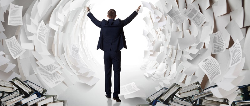 a person standing in a tunnel of papers. Containing the word: rules