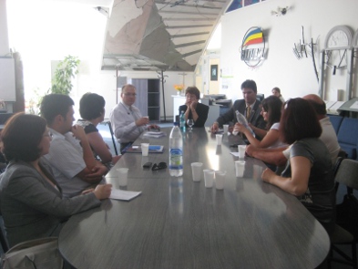 a group of people sitting around a table.