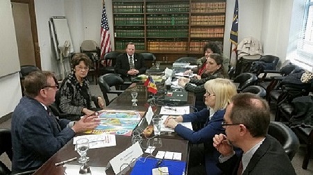 a group of people sitting around a table.