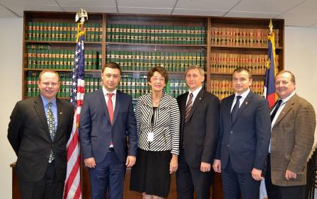 a group of people standing in front of a law bookcase.