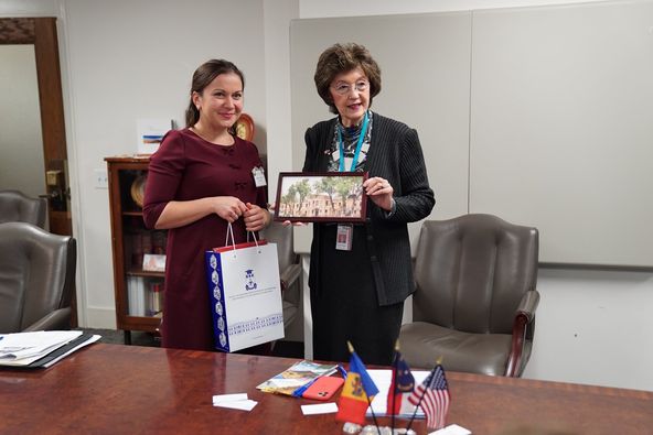 a person holding a picture frame and a person holding a picture.