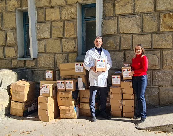 a person and person standing next to boxes.