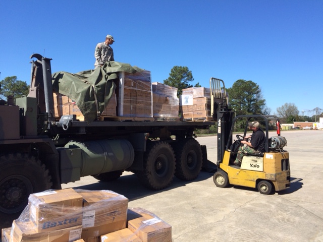 a person on a truck carrying boxes.