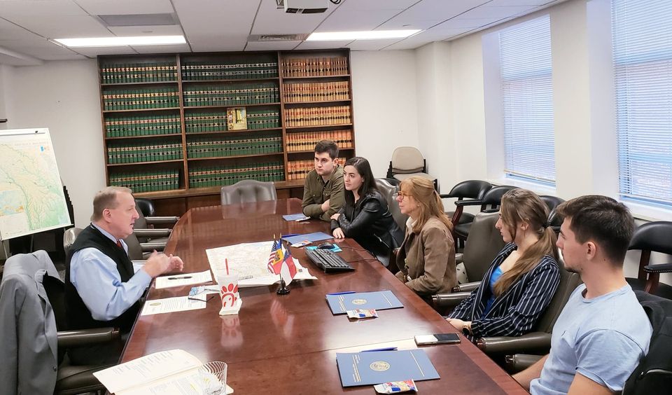 a group of people sitting around a table.